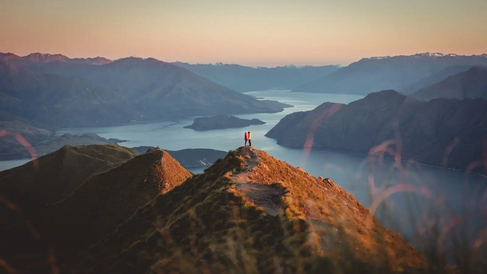 Sunrise turning the ridgelines gold above Lake Wānaka from Roys Peak